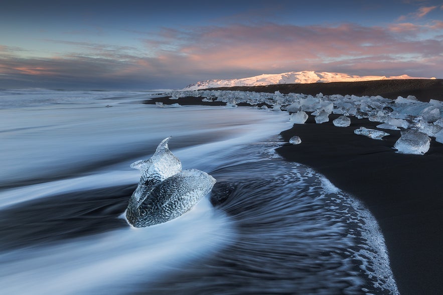 On the way to the ice caves, you can stop off for some wonderful photographic opportunities at the Jökulsárlón glacier lagoon, where large chunks of ice float about with the tide, as well as the nearby Breiðamerkursandur – more commonly known as the ‘ice beach’ – where you will find ice cubes like polished diamonds scattered over the sandy black beach.